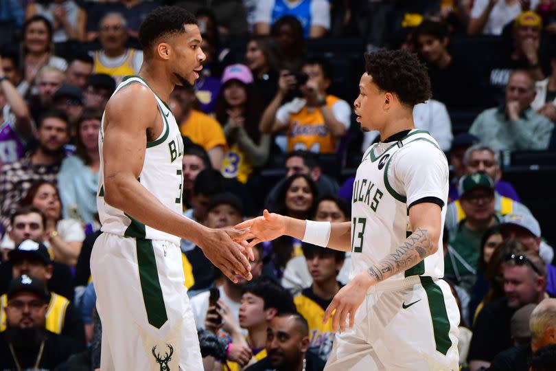 Ryan Rollins #13 and Giannis Antetokounmpo #34 of the Milwaukee Bucks high five during the game against the Los Angeles Lakers on March 20, 2025 at Crypto.Com Arena in Los Angeles, California