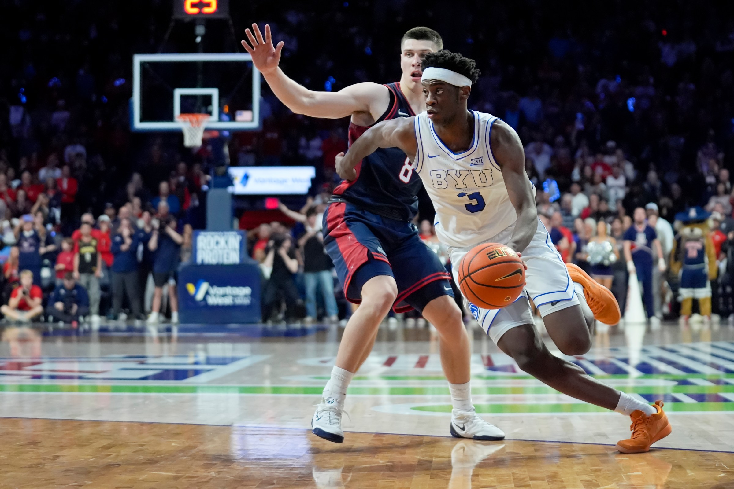 TUCSON, ARIZONA - FEBRUARY 18: AJ Dybantsa #3 of the BYU Cougars drives to the basket against Ivan Kharchenkov #8 of the Arizona Wildcats during the second half at McKale Center at ALKEME Arena on February 18, 2026 in Tucson, Arizona. (Photo by Patrick Mulligan/Getty Images)