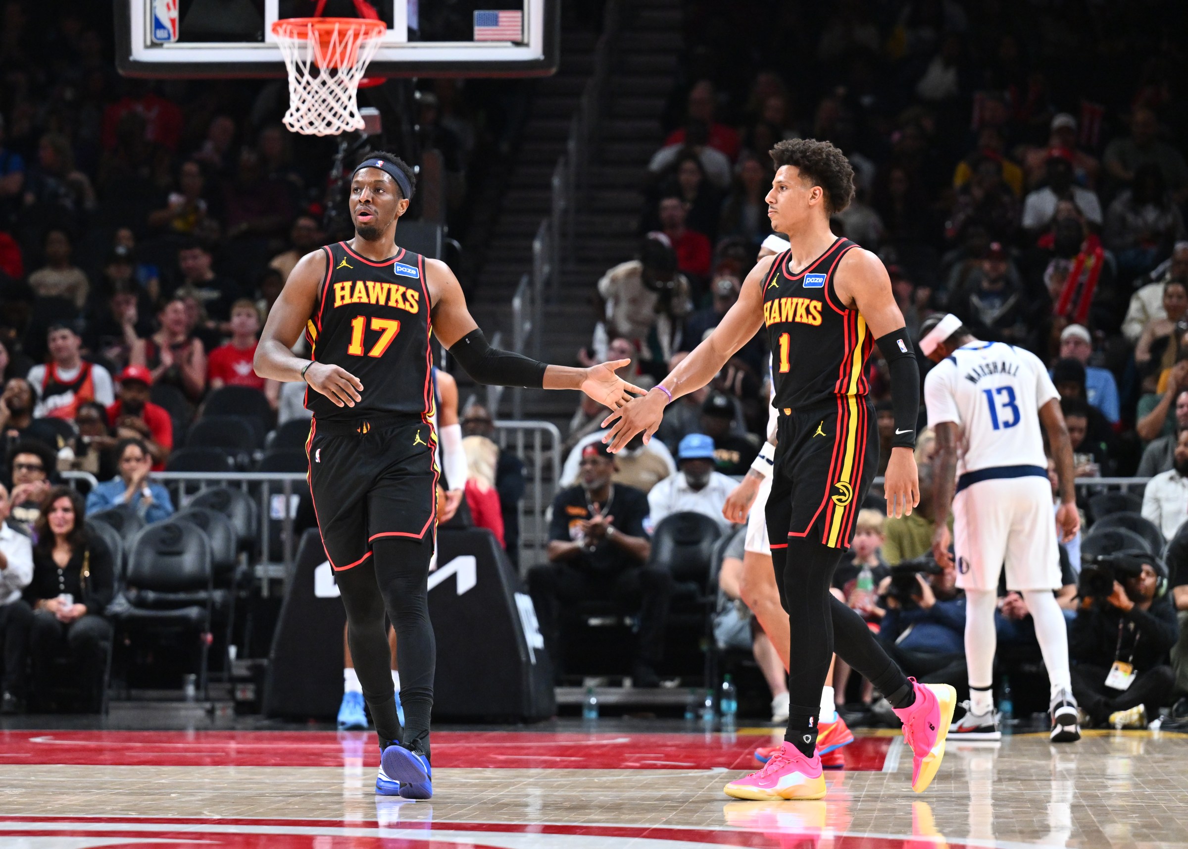 ATLANTA, GA - MARCH 10: Onyeka Okongwu #17 and Jalen Johnson #1 of the Atlanta Hawks high five during the game against the Dallas Mavericks on March 10, 2026 at State Farm Arena in Atlanta, Georgia. NOTE TO USER: User expressly acknowledges and agrees that, by downloading and/or using this Photograph, user is consenting to the terms and conditions of the Getty Images License Agreement. Mandatory Copyright Notice: Copyright 2026 NBAE (Photo by Adam Hagy/NBAE via Getty Images)