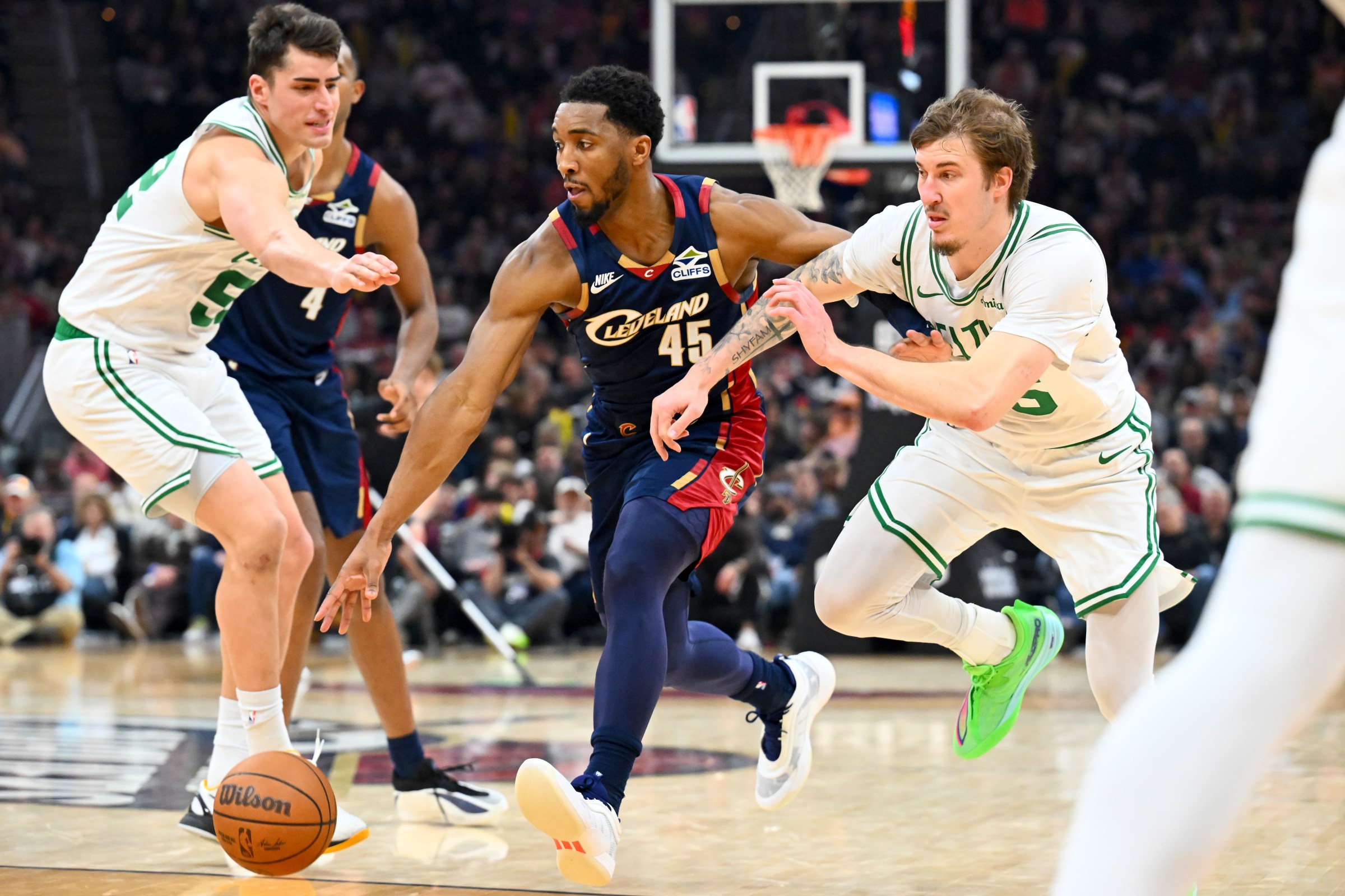 CLEVELAND, OHIO - MARCH 08: Donovan Mitchell #45 of the Cleveland Cavaliers drives between Luka Garza #52 and Baylor Scheierman #55 of the Boston Celtics during the fourth quarter at Rocket Arena on March 08, 2026 in Cleveland, Ohio. The Celtics defeated the Cavaliers 109-98. NOTE TO USER: User expressly acknowledges and agrees that, by downloading and or using this photograph, User is consenting to the terms and conditions of the Getty Images License Agreement. (Photo by Jason Miller/Getty Images)