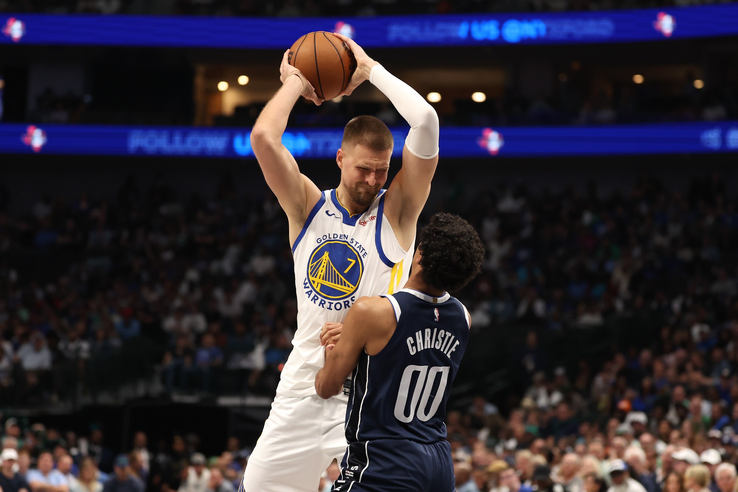 DALLAS, TEXAS - MARCH 23: Kristaps Porzingis #7 of the Golden State Warriors is defended by Max Christie #00 of the Dallas Mavericks during the second quarter at American Airlines Center on March 23, 2026 in Dallas, Texas. NOTE TO USER: User expressly acknowledges and agrees that, by downloading and or using this photograph, user is consenting to the terms and conditions of the Getty Images License Agreement. (Photo by Sam Hodde/Getty Images)