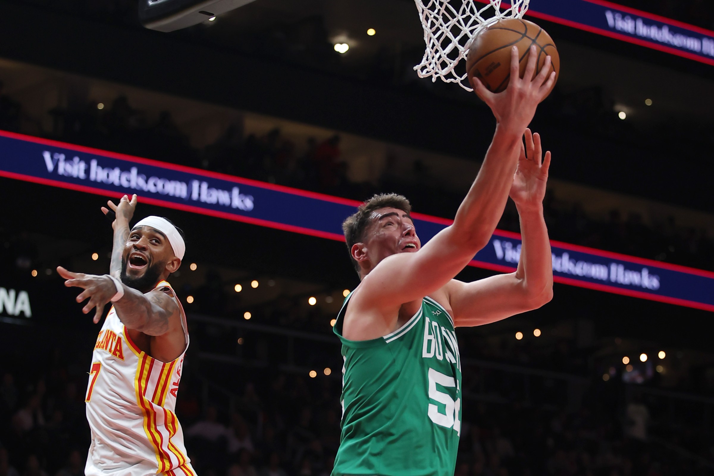 ATLANTA, GEORGIA - MARCH 30: Luka Garza #52 of the Boston Celtics lays up a shot against Nickeil Alexander-Walker #7 of the Atlanta Hawks in the first half at State Farm Arena on March 30, 2026 in Atlanta, Georgia. NOTE TO USER: User expressly acknowledges and agrees that, by downloading and or using this Photograph, user is consenting to the terms and conditions of the Getty Images License Agreement. (Photo by Jonathan Bachman/Getty Images)
