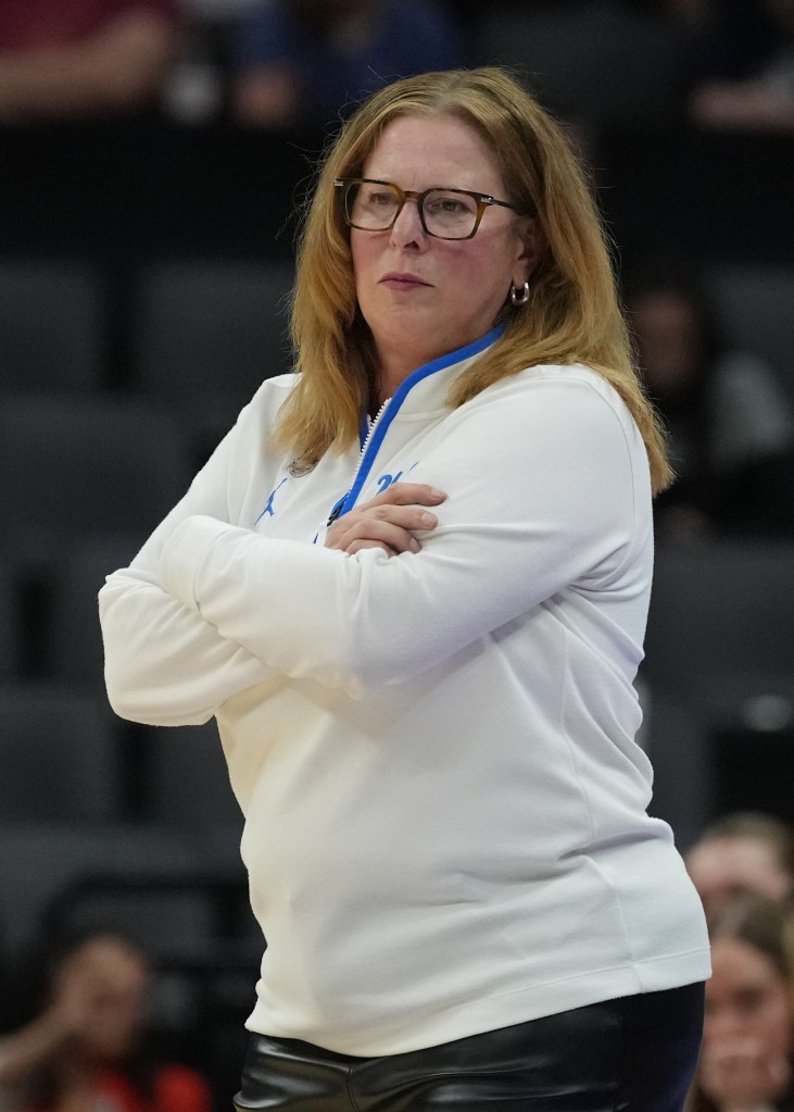 UCLA Bruins head coach Cori Close watches from the sidelines during a women's college basketball game.