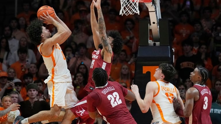 Tennessee guard Ja'kobi Gillespie, left, shoots the allover Alabama guard...