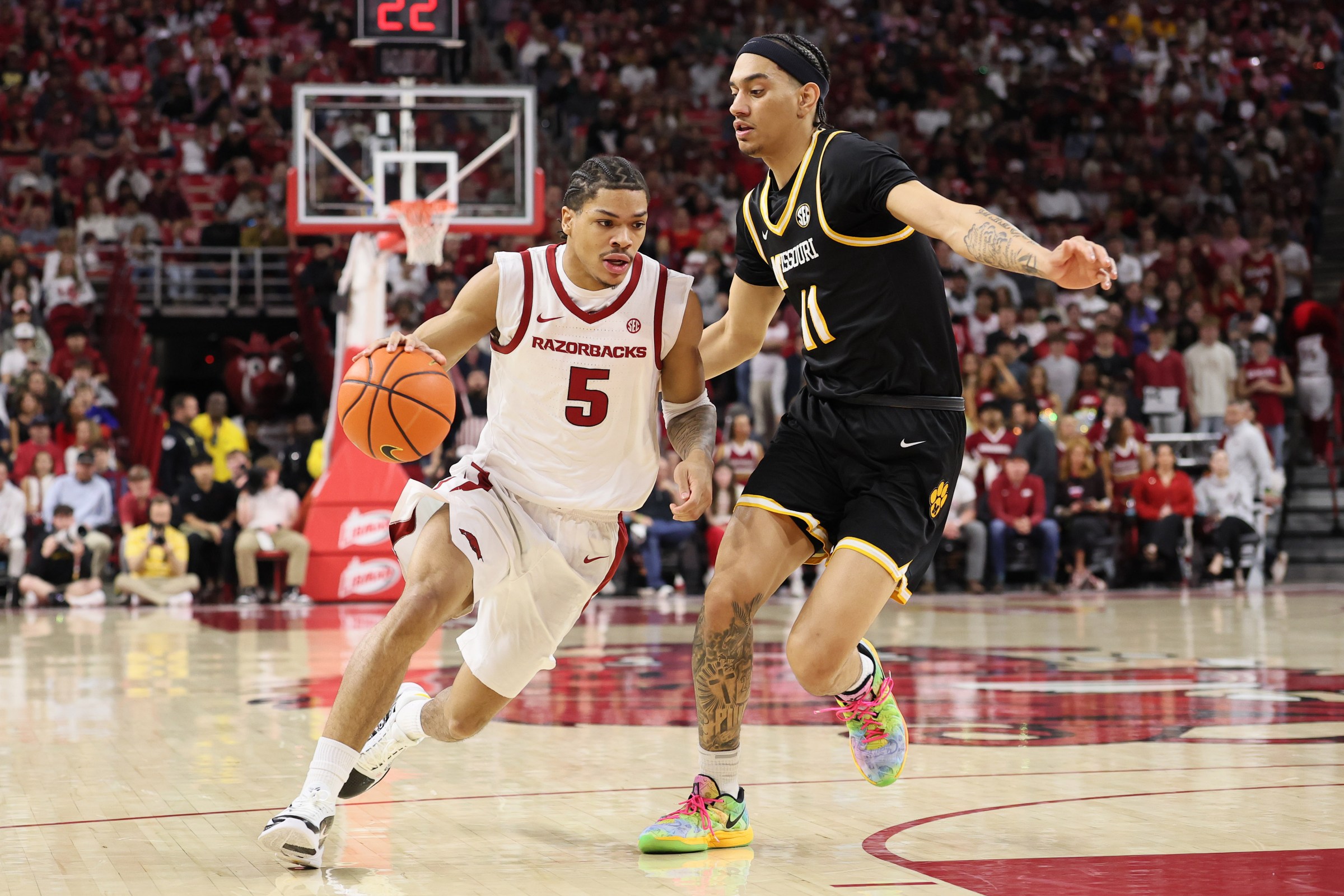 Feb 21, 2026; Fayetteville, Arkansas, USA; Arkansas Razorbacks guard Darius Acuff Jr (5) drives against Missouri Tigers guard Trent Pierce (11) during the first half at Bud Walton Arena. Mandatory Credit: Nelson Chenault-Imagn Images