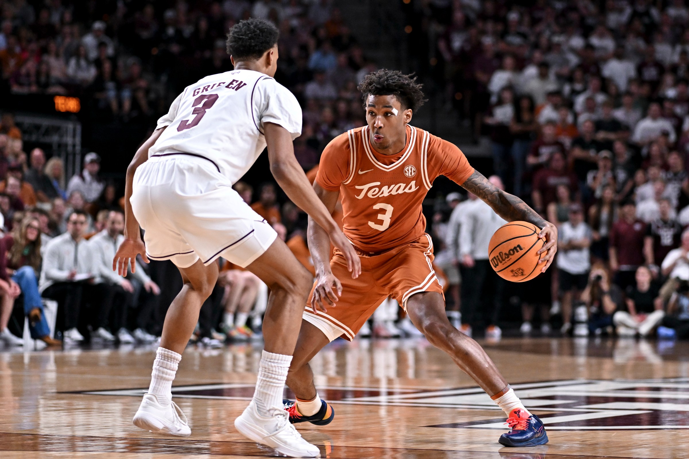 Feb 28, 2026; College Station, Texas, USA; Texas Longhorns guard Dailyn Swain (3) controls the ball during the first half as Texas A&M Aggies guard Rylan Griffen (3) defends at Reed Arena. Mandatory Credit: Maria Lysaker-Imagn Images