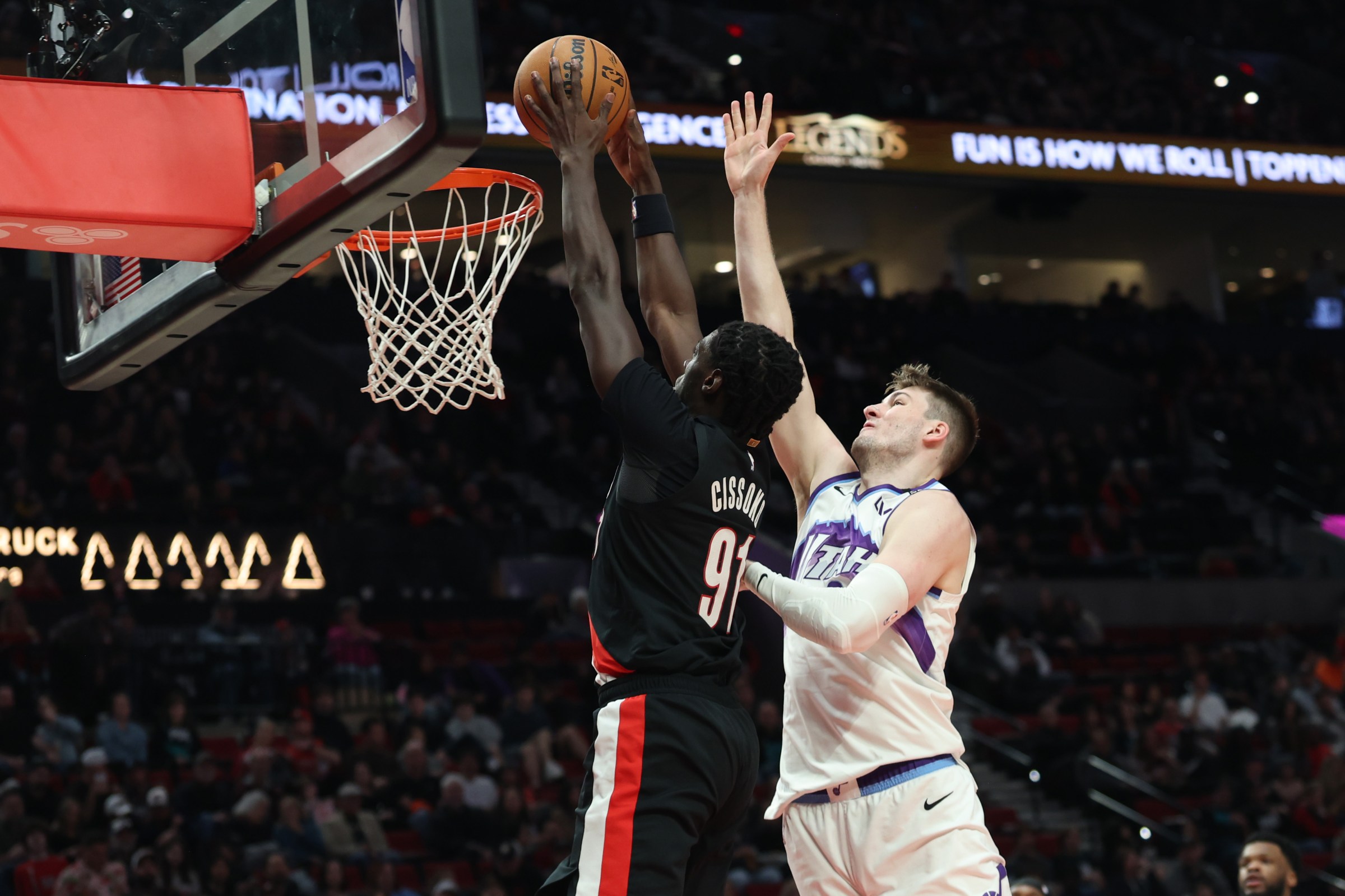 Mar 13, 2026; Portland, Oregon, USA; Portland Trail Blazers guard Sidy Cissoko (91) dunks the ball over Utah Jazz center Kyle Filipowski (22) during the second half at Moda Center. Mandatory Credit: Jaime Valdez-Imagn Images