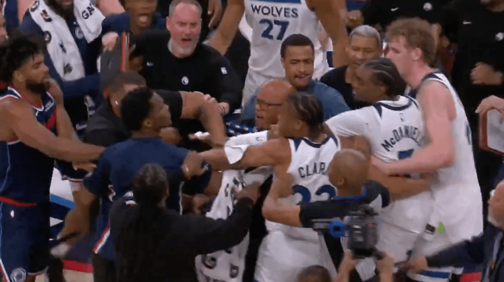 A basketball game fight between the Clippers and Timberwolves, with players and officials tangled up.