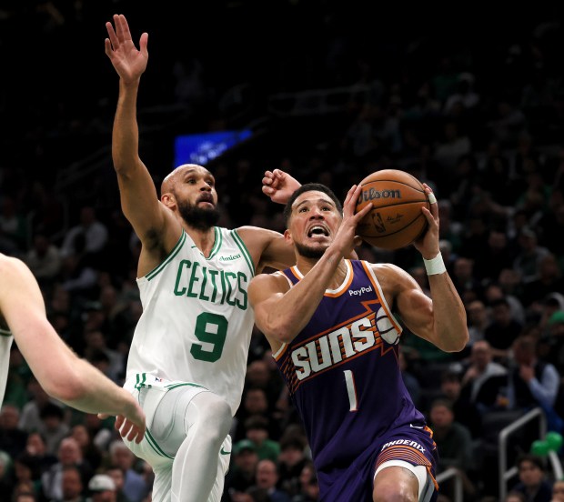 Phoenix Suns guard Devin Booker (1) goes to the basket defended by Boston Celtics guard Derrick White (9) during the second quarter of the game at TD Garden. (Nancy Lane/Boston Herald)