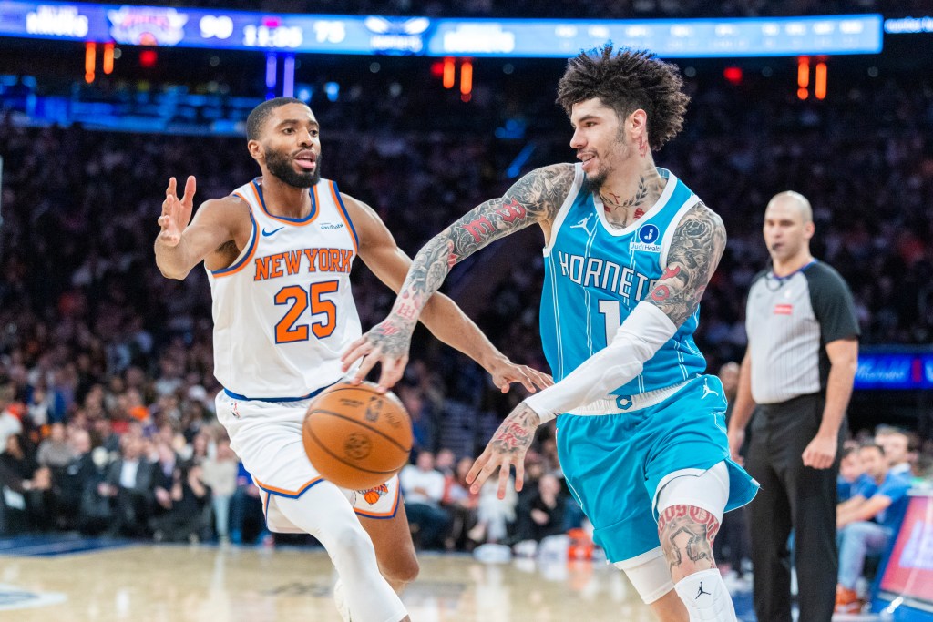 Charlotte Hornets guard LaMelo Ball (1) makes a bounce pass in front of New York Knicks guard Mikal Bridges (25).