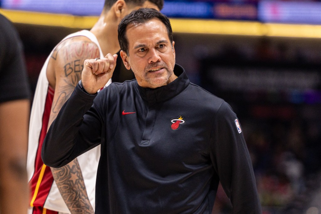 Miami Heat Head Coach Erik Spoelstra clenches his fist while reacting to a timeout call.