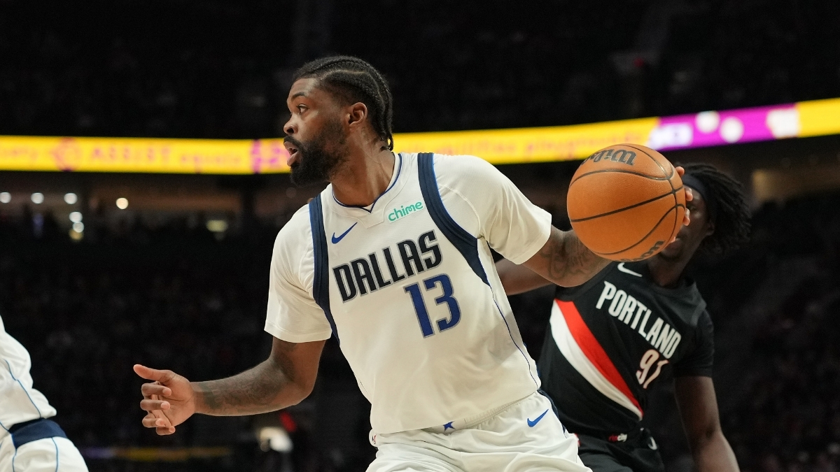 Naji Marshall #13 of the Dallas Mavericks drives with the ball against the Portland Trail Blazers at Moda Center.