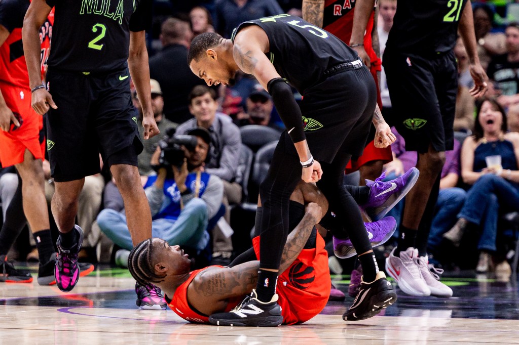 New Orleans Pelicans guard Dejounte Murray (5) leans over Toronto Raptors guard Jamal Shead (23) after making a 3-point basket.