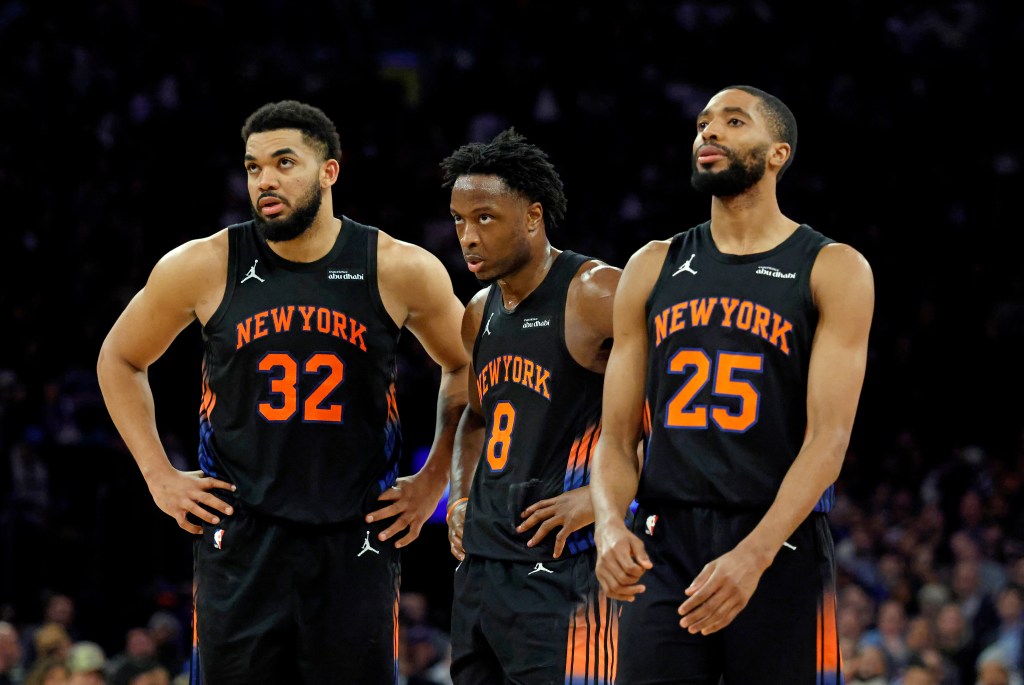 New York Knicks players Karl-Anthony Towns, Og Anunoby, and Mikal Bridges react on the court.