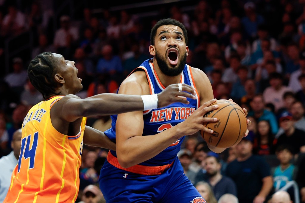 Karl-Anthony Towns of the New York Knicks prepares to shoot against Moussa Diabate of the Charlotte Hornets.