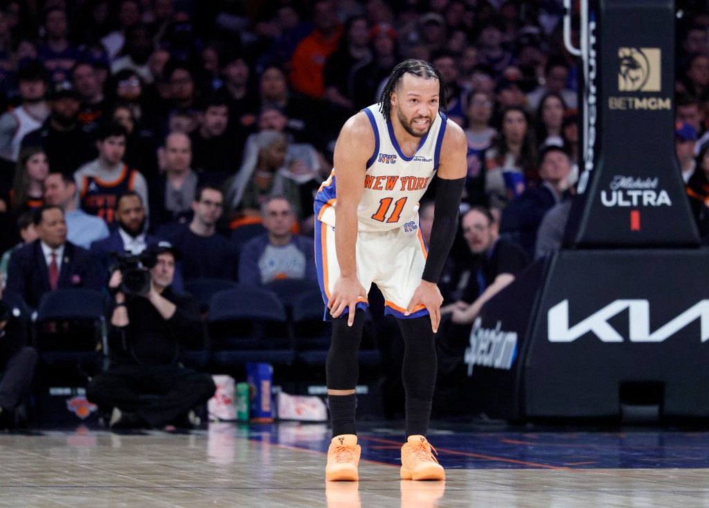 New York Knicks guard Jalen Brunson reacts after a Washington Wizards player landed on his leg.