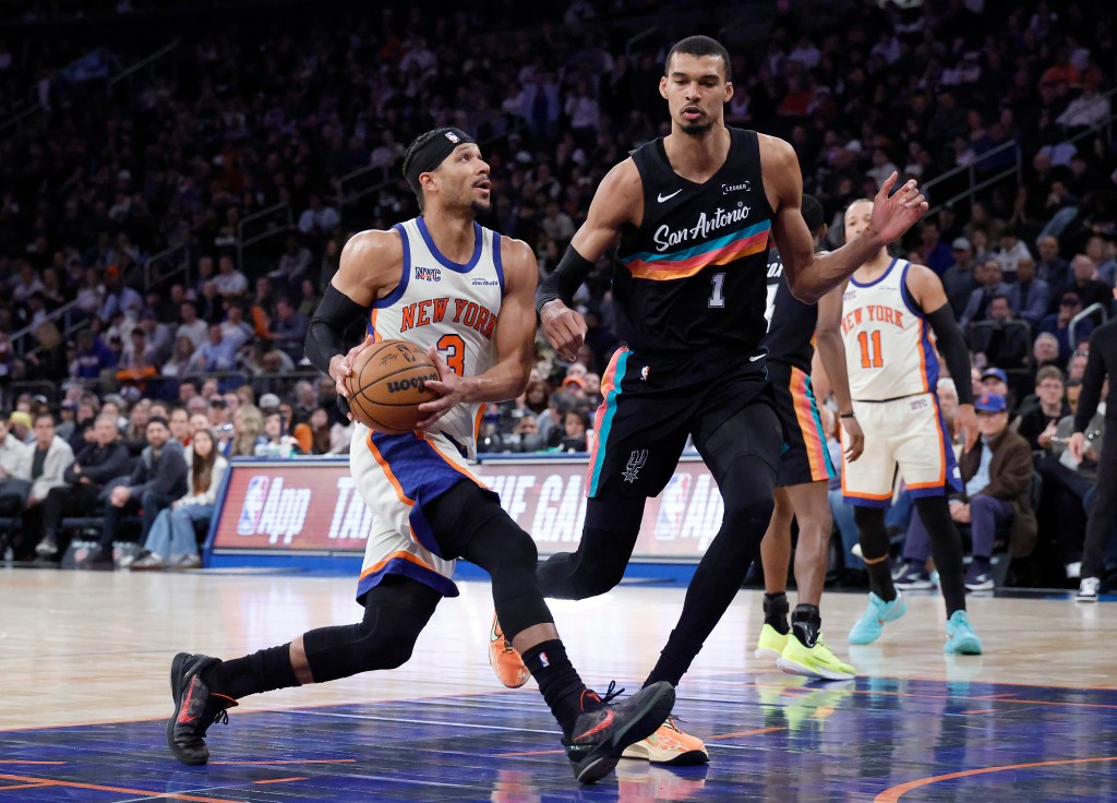 New York Knicks guard Josh Hart drives to the basket as San Antonio Spurs forward Victor Wembanyama gives chase.