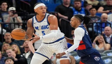 Orlando Magic forward Paolo Banchero (5) looks to pass the ball as Washington Wizards guard Bub Carrington defends during the first half of an NBA basketball game, Tuesday, March 3, 2026, in Orlando, Fla. (AP Photo/John Raoux)