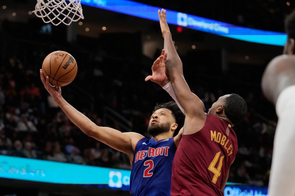 Detroit Pistons guard Cade Cunningham (2) shoots as Cleveland Cavaliers center Evan Mobley (4) defends. 