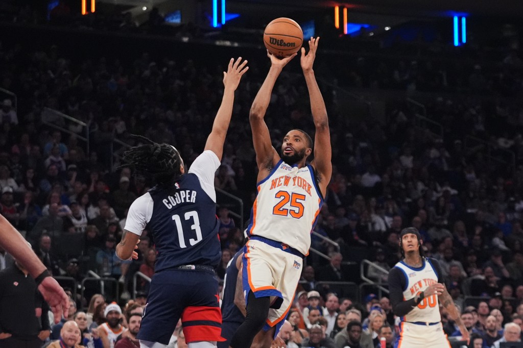 Mikal Bridges (25) of the Knicks shoots over the Wizards' Sharife Cooper (13) on March 22, 2026.