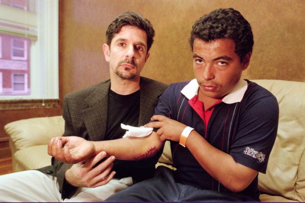 Jorge Lugo, right, shows his injured arm that required stitches, with his lawyer Mark NeJame in Orlando, Fla., Sunday, Oct., 26, 1997. Lugo was involved in an altercation early Sunday morning with Houston Rockets' Charles Barkley at Church Street Station, an entertainment district in Orlando which resulted in Lugo being thrown through a plate glass window by Barkley. Barkley was arrested and charged with aggravated battery and resisting arrest without violence, police said. He was jailed for five hours before being released on $6,000 bond.(AP Photo/The Orlando Sentinel, Tom Spitz) ORG XMIT: DO105