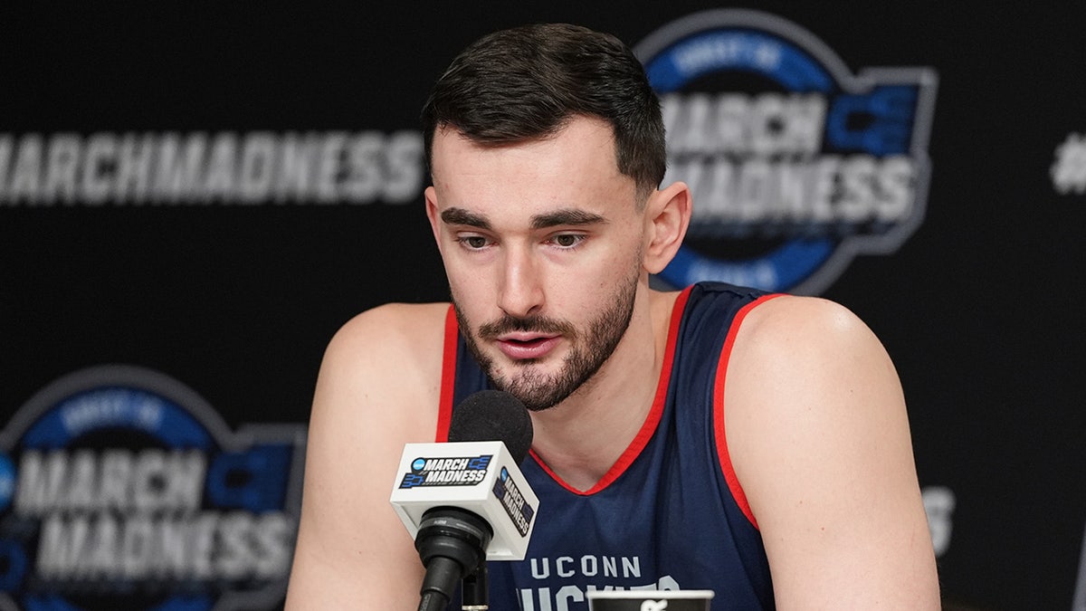 Alex Karaban talks to reporters