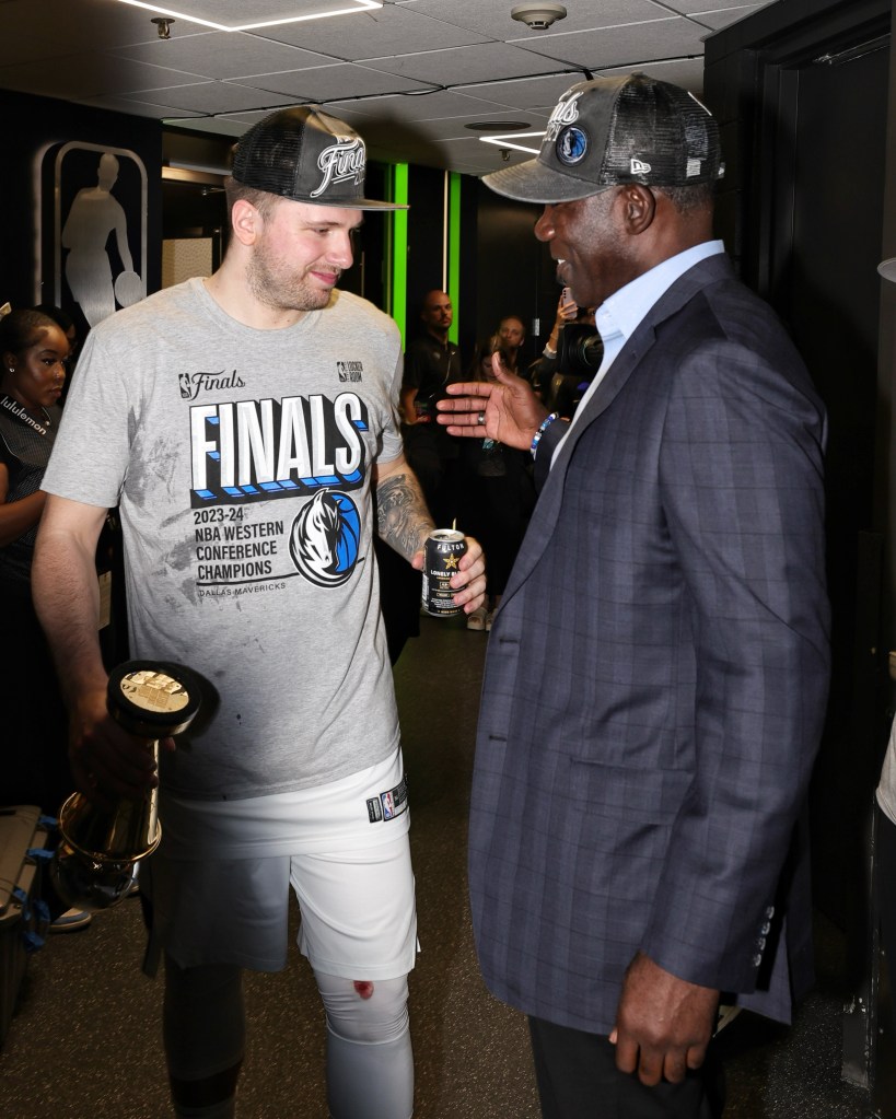 Luka Doncic and Michael Finley share a moment after the Mavericks win the Western Conference Finals.