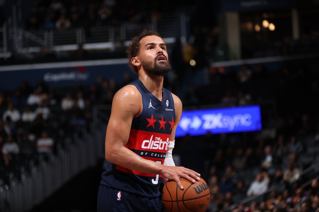 Trae Young of the Washington Wizards looks up, preparing for a free throw.