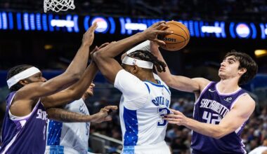 Orlando Magic center/forward Wendell Carter Jr. (34) fights for the ball with Sacramento Kings center Maxime Raynaud (42) during the first half of an NBA basketball game, Thursday, March 26, 2026, in Orlando, Fla. (AP Photo/Willie J. Allen Jr.)