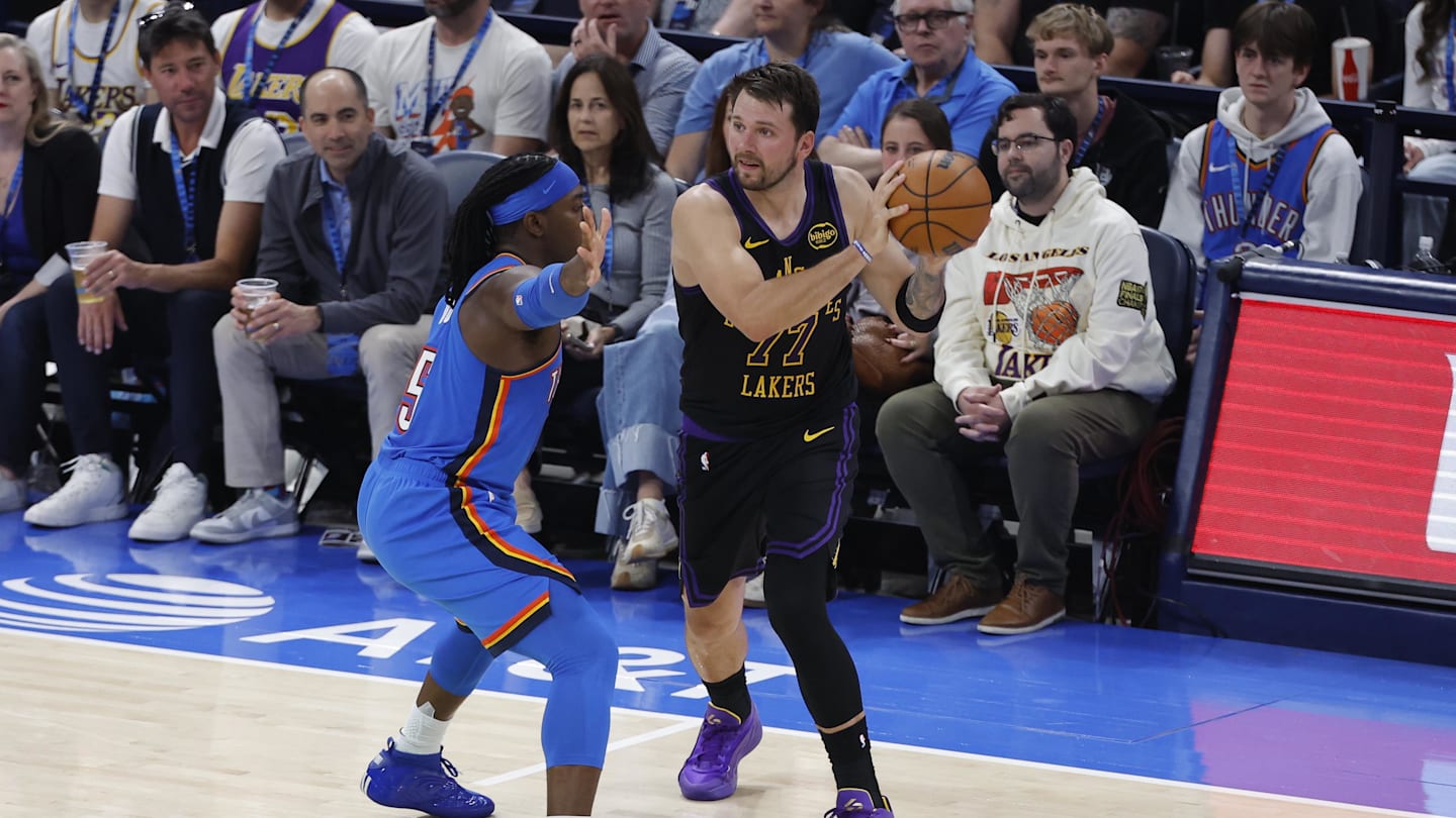 Apr 2, 2026; Oklahoma City, Oklahoma, USA; Los Angeles Lakers guard Luka Doncic (77) passes around Oklahoma City Thunder guard Luguentz Dort (5) during the second quarter at Paycom Center. Mandatory Credit: Alonzo Adams-Imagn Images