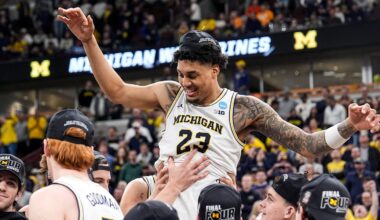 Michigan players pick up forward Yaxel Lendeborg (23) to celebrate winning the NCAA Tournament Midwest Regional Championship trophy after 95-62 win over Tennessee at United Center in Chicago on Sunday, March 29, 2026.