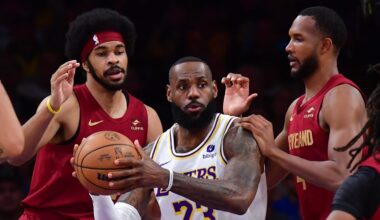Apr 6, 2024; Los Angeles, California, USA;  Los Angeles Lakers forward LeBron James (23) controls the ball against Cleveland Cavaliers center Jarrett Allen (31) forward Evan Mobley (4) and guard Darius Garland (10) during the first half at Crypto.com Arena. Mandatory Credit: Gary A. Vasquez-Imagn Images