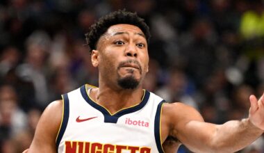 Jan 14, 2026; Dallas, Texas, USA; Denver Nuggets guard Jalen Pickett (24) passes the ball by Dallas Mavericks guard Ryan Nembhard (9) during the second quarter at the American Airlines Center. Mandatory Credit: Jerome Miron-Imagn Images