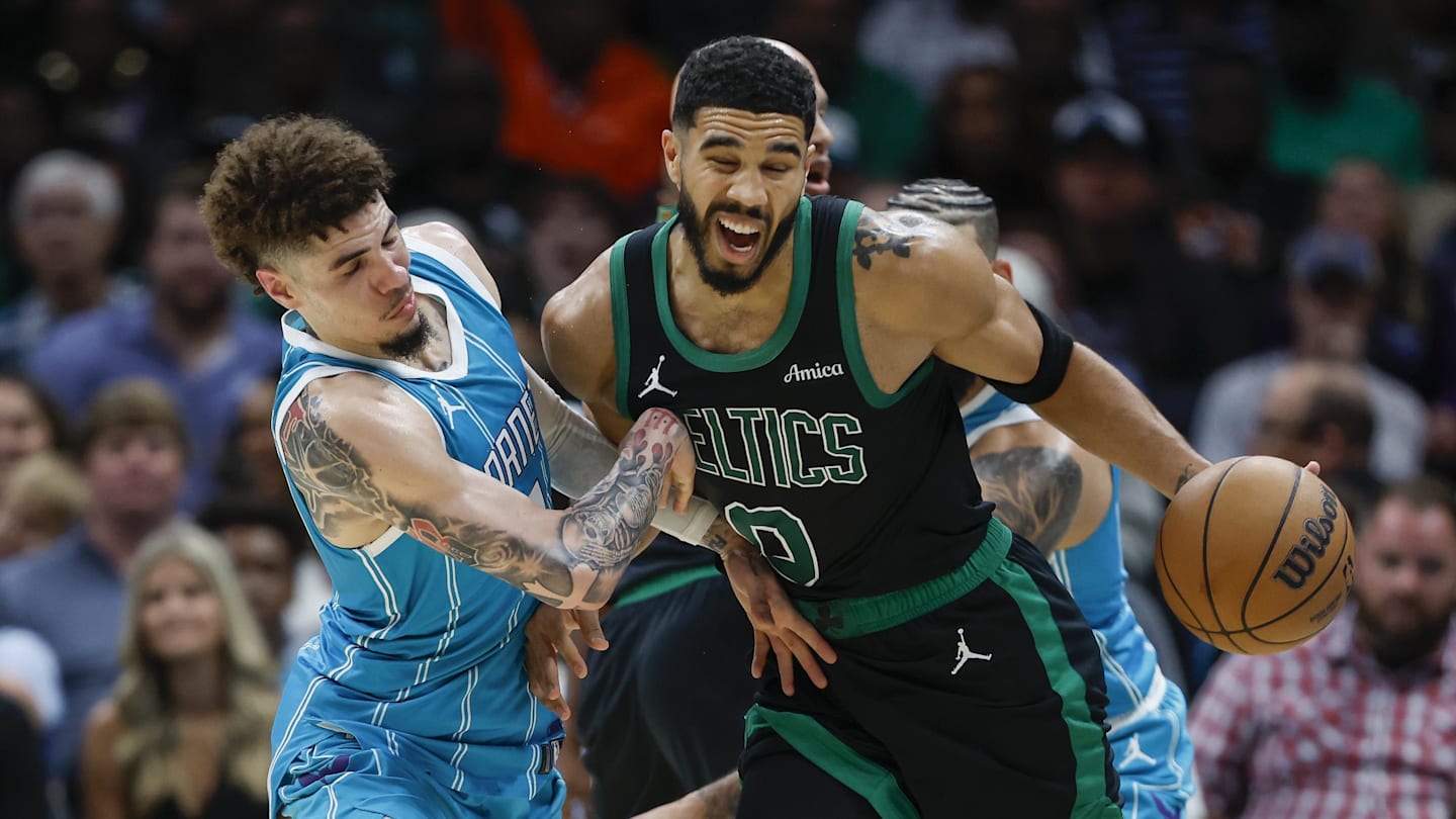 Nov 2, 2024; Charlotte, North Carolina, USA; Boston Celtics forward Jayson Tatum (0) collides with Charlotte Hornets guard LaMelo Ball (1) during the second half at Spectrum Center. Mandatory Credit: Nell Redmond-Imagn Images