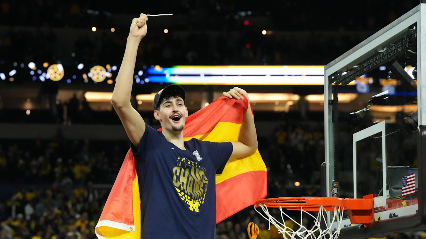 Apr 6, 2026; Indianapolis, IN, USA; Michigan Wolverines center Aday Mara (15) celebrates after cutting down a piece of the net after defeating the Connecticut Huskies in the national championship of the Final Four of the men's 2026 NCAA Tournament at Lucas Oil Stadium. Mandatory Credit: Robert Deutsch-Imagn Images