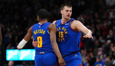 Mar 5, 2024; Denver, Colorado, USA; Denver Nuggets forward Peyton Watson (8) and center Nikola Jokic (15) react in the first half against the Phoenix Suns at Ball Arena. Mandatory Credit: Ron Chenoy-Imagn Images