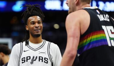 Apr 4, 2026; Denver, Colorado, USA; San Antonio Spurs guard Stephon Castle (5) reacts towards Denver Nuggets center Nikola Jokic (15) in the third quarter at Ball Arena. Mandatory Credit: Ron Chenoy-Imagn Images