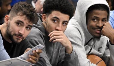Nov 22, 2025; Dallas, Texas, USA; Memphis Grizzlies guard Ja Morant (center) looks on from the team bench during the first quarter against the Dallas Mavericks at the American Airlines Center. Mandatory Credit: Jerome Miron-Imagn Images