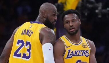 Los Angeles Lakers forward LeBron James (23) talks with son Bronny James (9)