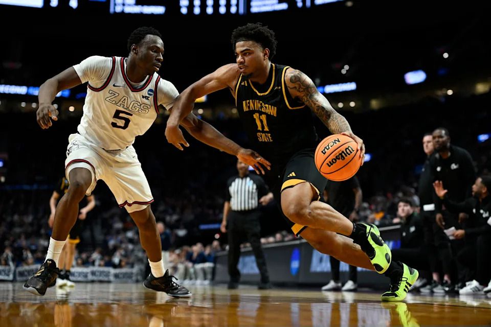 Kennesaw State Owls guard RJ Johnson (11) drives against Gonzaga Bulldogs forward Emmanuel Innocenti (5) during the second half of a first round game of the men's 2026 NCAA Tournament