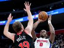 Jalen Duren of the Detroit Pistons shoots the ball against Jakob Poeltl of the Toronto Raptors during the first quarter at Little Caesars Arena on March 31, 2026 in Detroit.