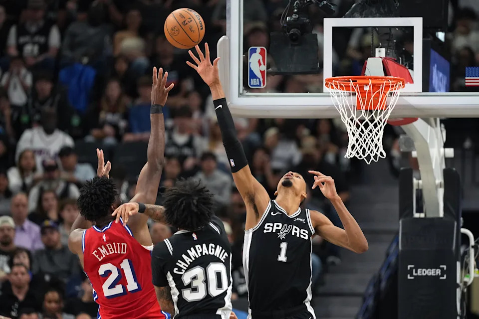Apr 6, 2026; San Antonio, Texas, USA; Philadelphia 76ers center Joel Embiid (21) shoots over San Antonio Spurs forward Victor Wembanyama (1) during the first half at Frost Bank Center. Mandatory Credit: Scott Wachter-Imagn Images