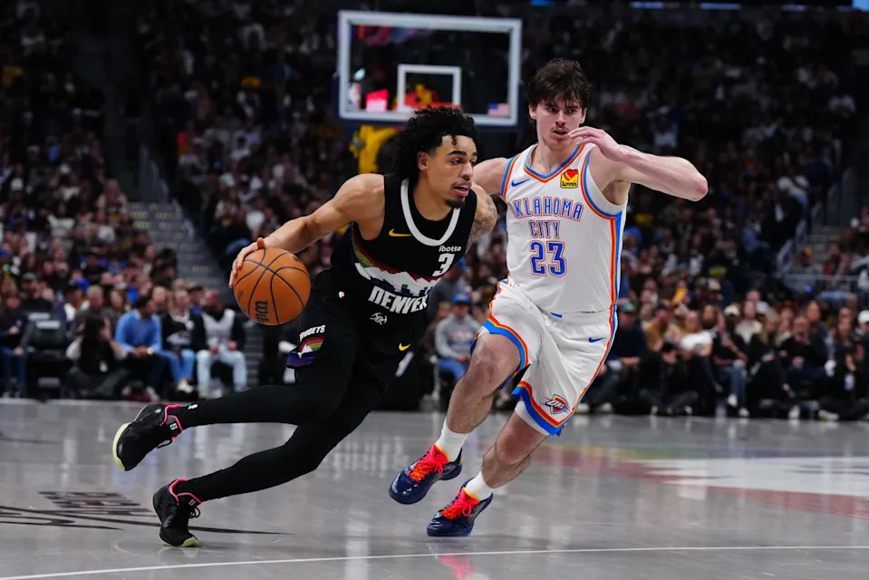 Apr 10, 2026; Denver, Colorado, USA; Oklahoma City Thunder forward Brooks Barnhizer (23) defends on Denver Nuggets guard Julian Strawther (3) in the second half at Ball Arena. Mandatory Credit: Ron Chenoy-Imagn Images