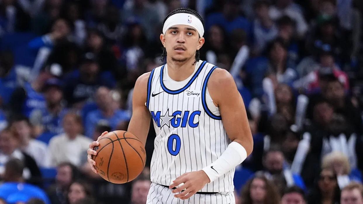 Anthony Black dribbling basketball on court during game at Kia Center
