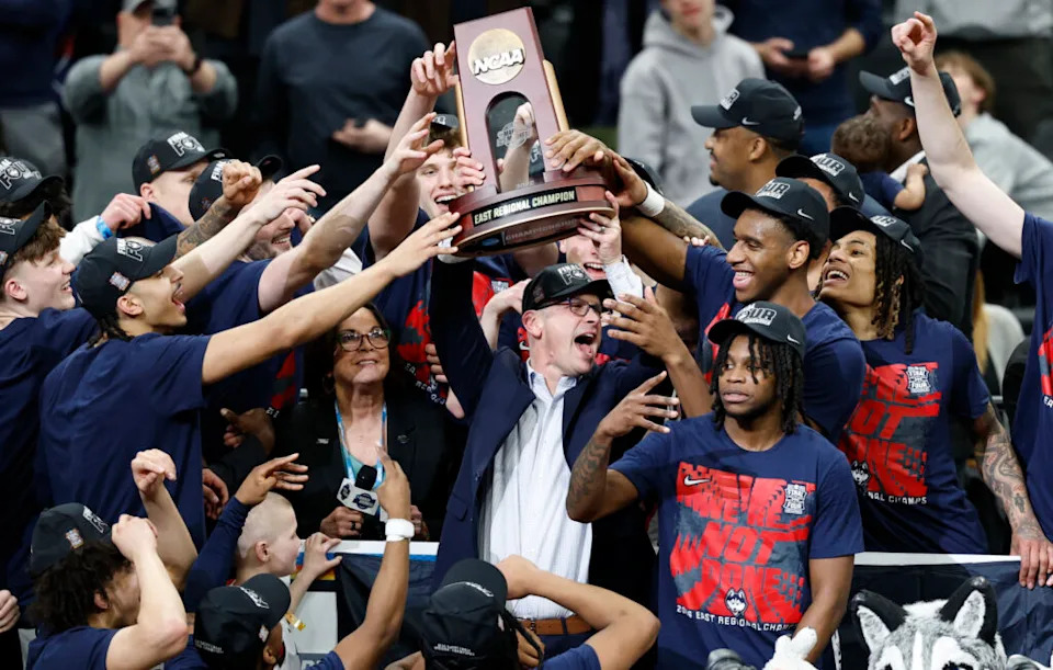 UConn Huskies head coach Dan Hurley hoists the east regional trophy