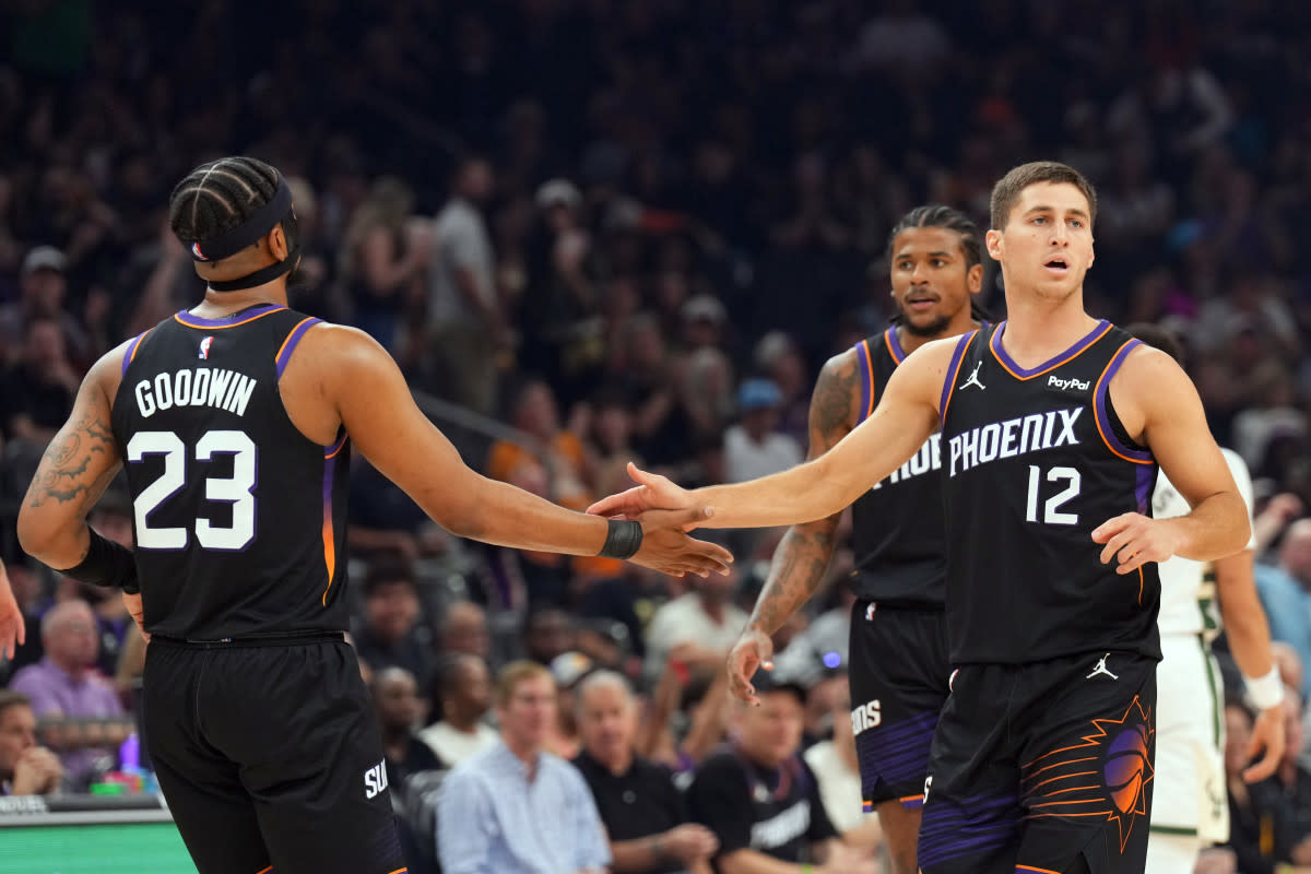 Phoenix Suns guard Jordan Goodwin (left) and Phoenix Suns guard Collin Gillespie (right) slap hands against the Milwaukee Bucks during the first half at Mortgage Matchup Center. Joe Camporeale-Imagn Images