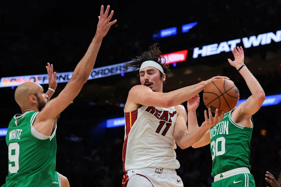 Apr 1, 2026; Miami, Florida, USA; Miami Heat forward Jaime Jaquez Jr. (11) protects the basketball from Boston Celtics guard Derrick White (9) during the second quarter at Kaseya Center. Mandatory Credit: Sam Navarro-Imagn Images