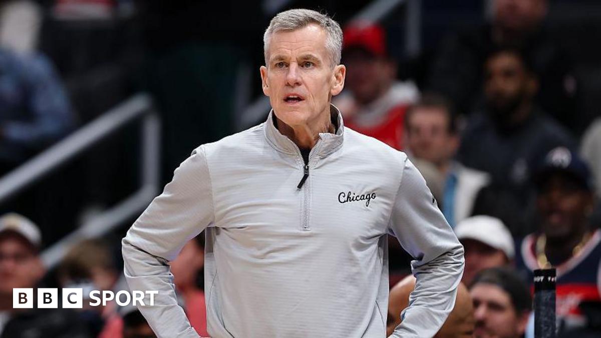 Billy Donovan is wearing a grey top and has his hands on his hips