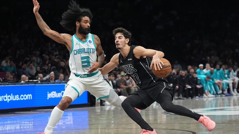 Charlotte Hornets' Coby White (3) defends Brooklyn Nets' Ben Saraf...