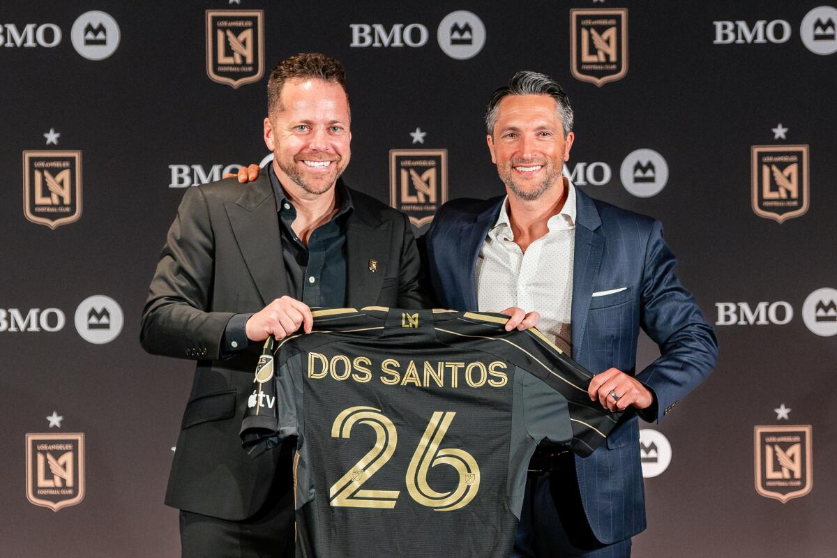 Marc Dos Santos, left, poses for a photo for general manager John Thorrington.